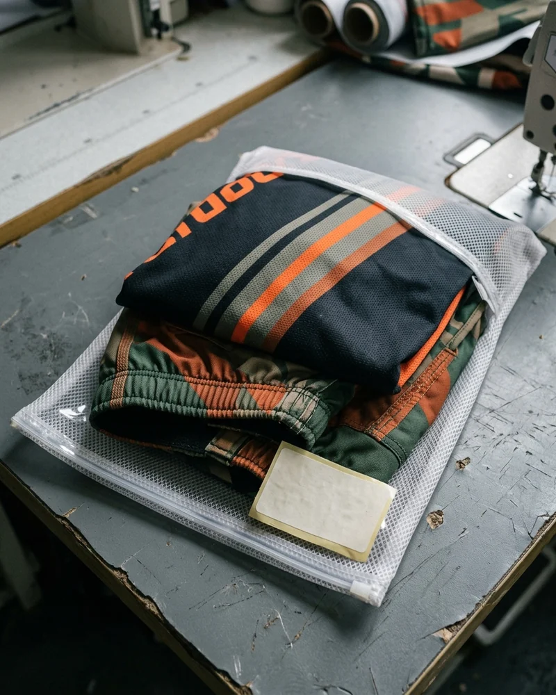 Jersey and pants folded together in one labelled rider bag